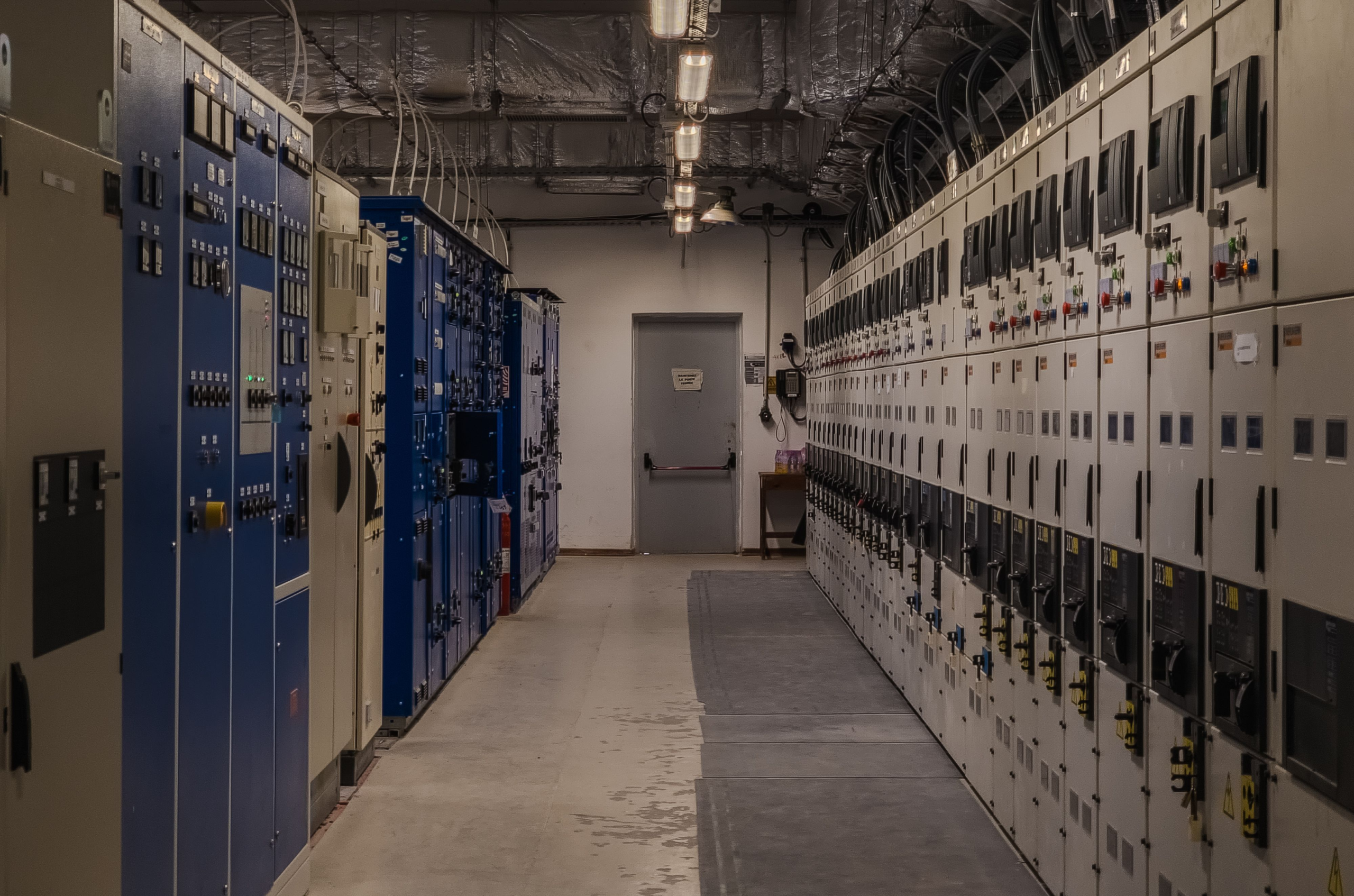 An industrial control room with electrical panels.